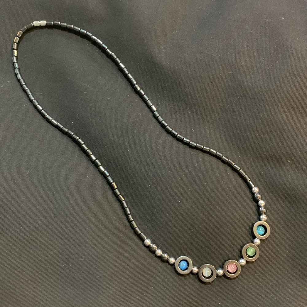 Necklace. 22 inch long with multicolored stones on a black chain.